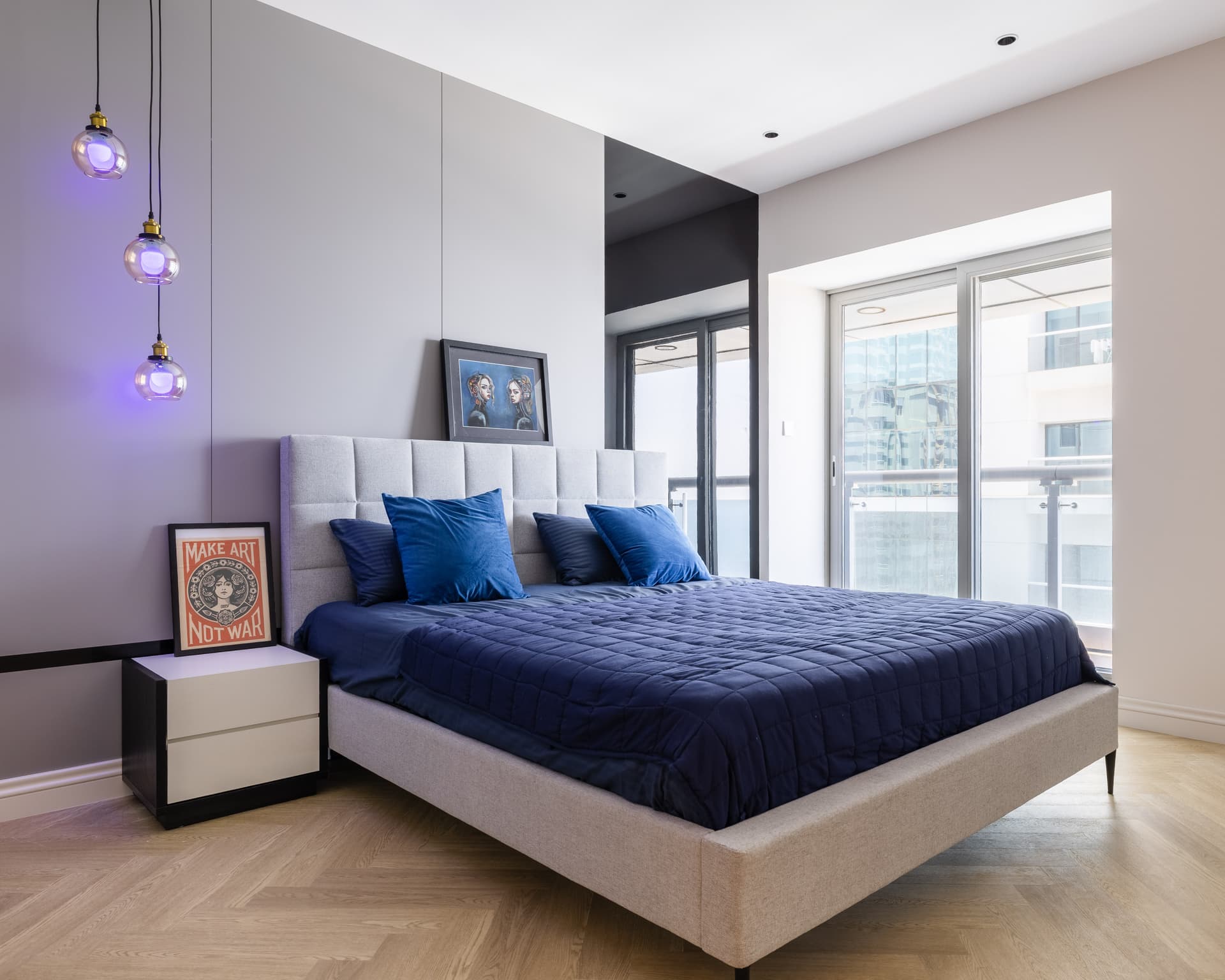Bright luxury Dubai Marina apartment living room with cream furniture, contemporary art and open-plan dining